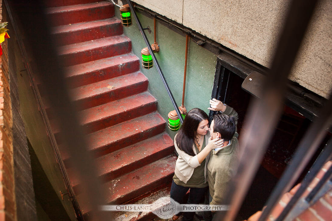 Wilmington-NC-Engagement-Photography-Lifestyle Engagment Session-Picture-Ideas-Inspiration-Couple hugging at bottom of the stairs