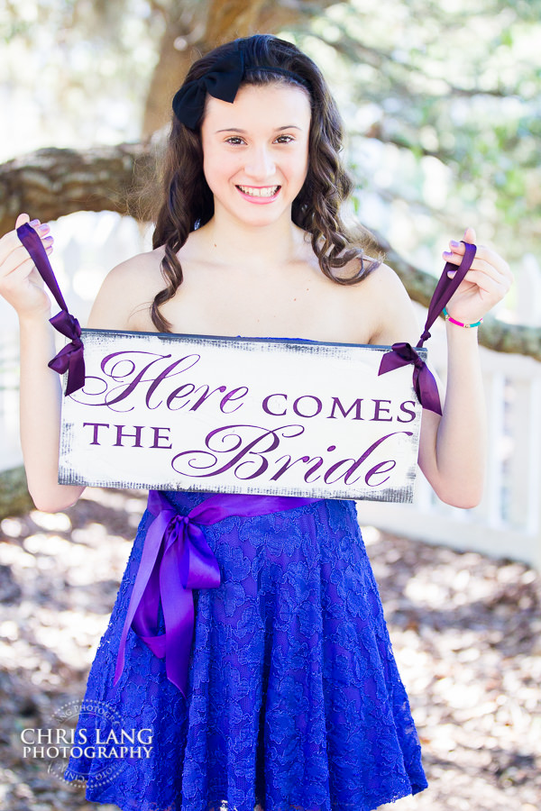 Flower girl holding  a here comes the bride sign - the village chapel - Bald Head Island NC - wedding photography ideas