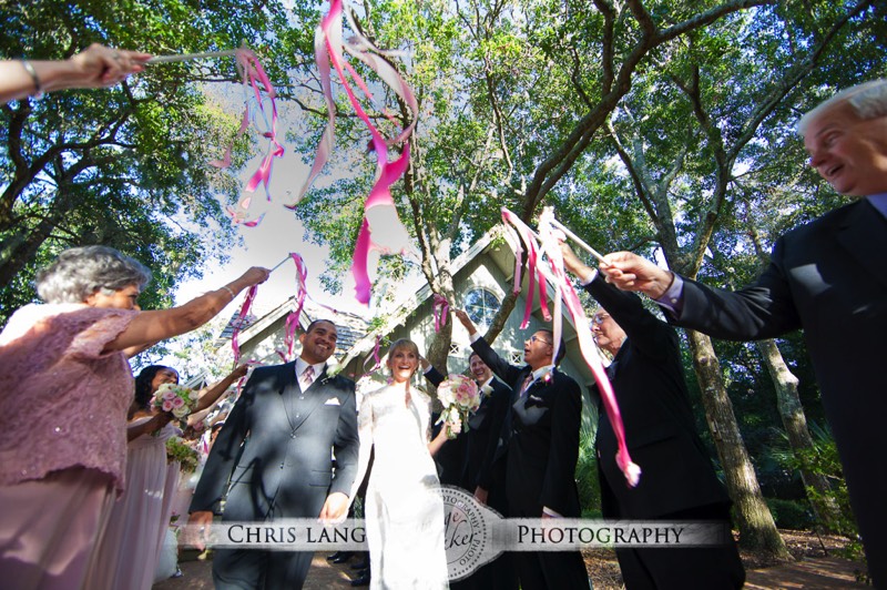 Picture of couples exit from the Village Chapel on Bald Head Island after Ceremony.  Bald head Island Photographers