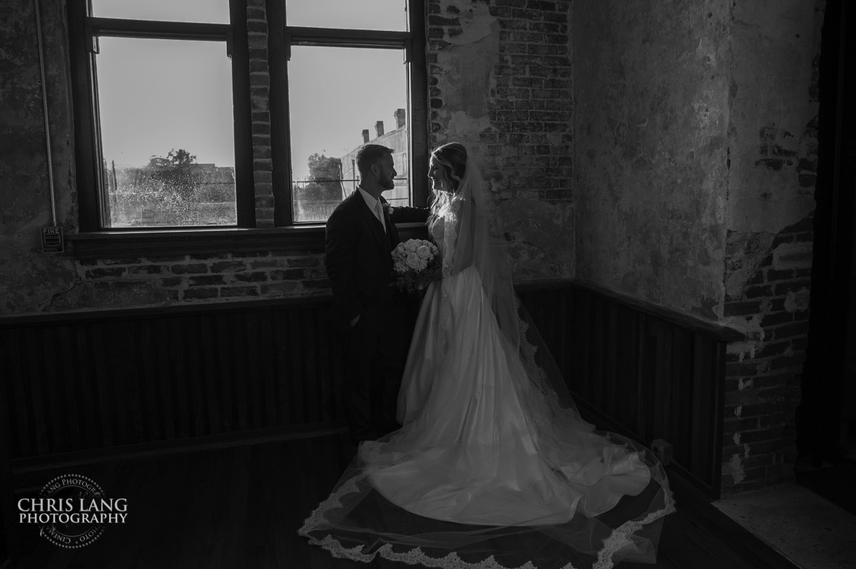 Bride and groom upstairs at the Brooklyn arts Center - brick and stucco - rustic wedding - wedding dress - romantic - brooklyn arts center - weddings - wedding venue -  wedding photo - ideas - wilmington nc - chris lang photography 