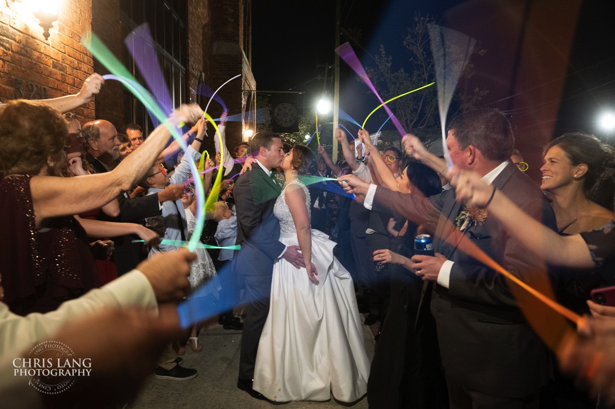 Bride and groom exit - glow sticks -  kiss - brooklyn arts center - weddings - wedding venue -  wedding photo - ideas - wilmington nc - chris lang photography 