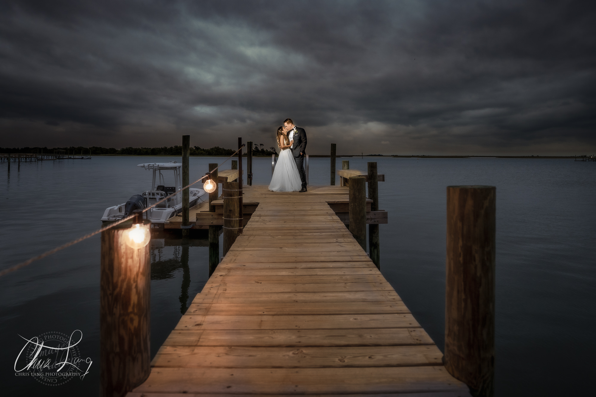 Bride and groom kissingi in a winery inbetween wine barrels - Wedding Photograpy Ideas -lWIlmington NC Wedding Photographers - 
