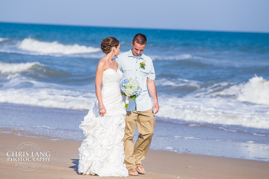 Bride and Groom walking ont he beach  - oak island wedding photographers - oak island wedding image - beach wedding photography - beach wedding ideas -
