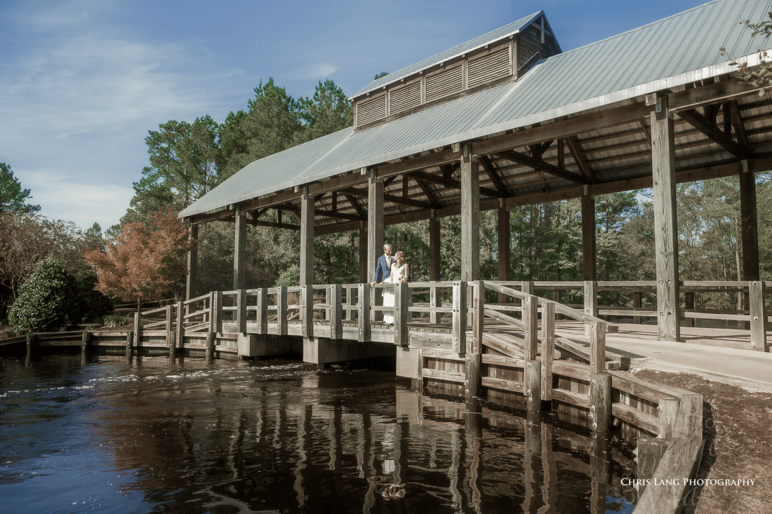 Animated image of the covered bridage at RIver Landing with a Bride & Groom overlooking the Cape Fear River