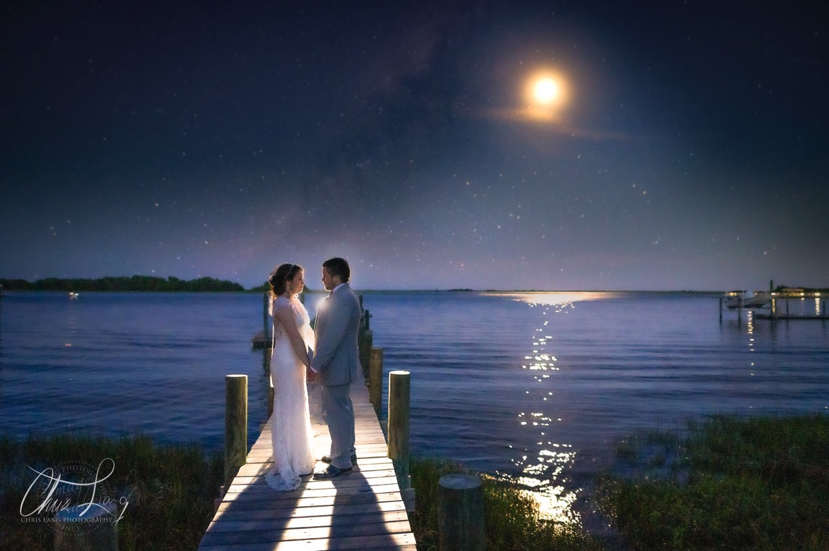 bride & groom on a dock under the moon on the intercoastal waterway - 