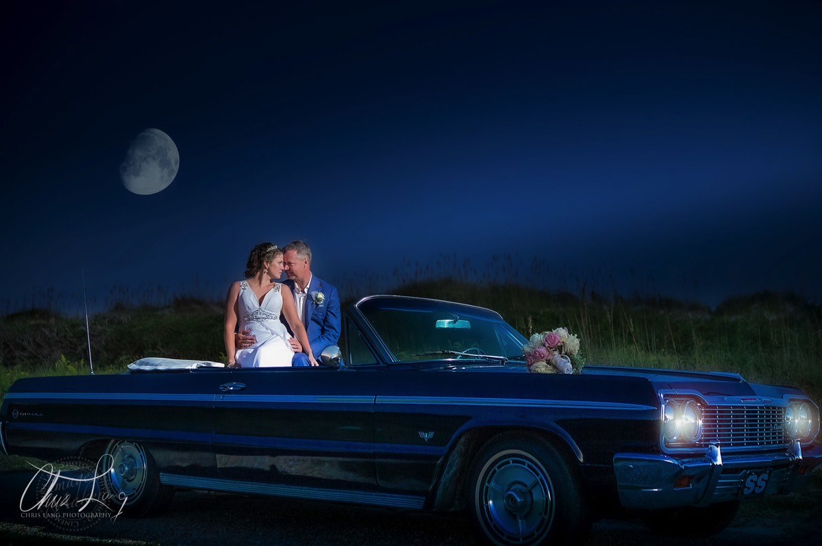 bride & groom sitting in a callsi convertable car - moonlight - twilight photo - wilmington nc wedding photographers - creative wedding photo - signature portrats - wedding ideas - bride - groom - wedding dress - 