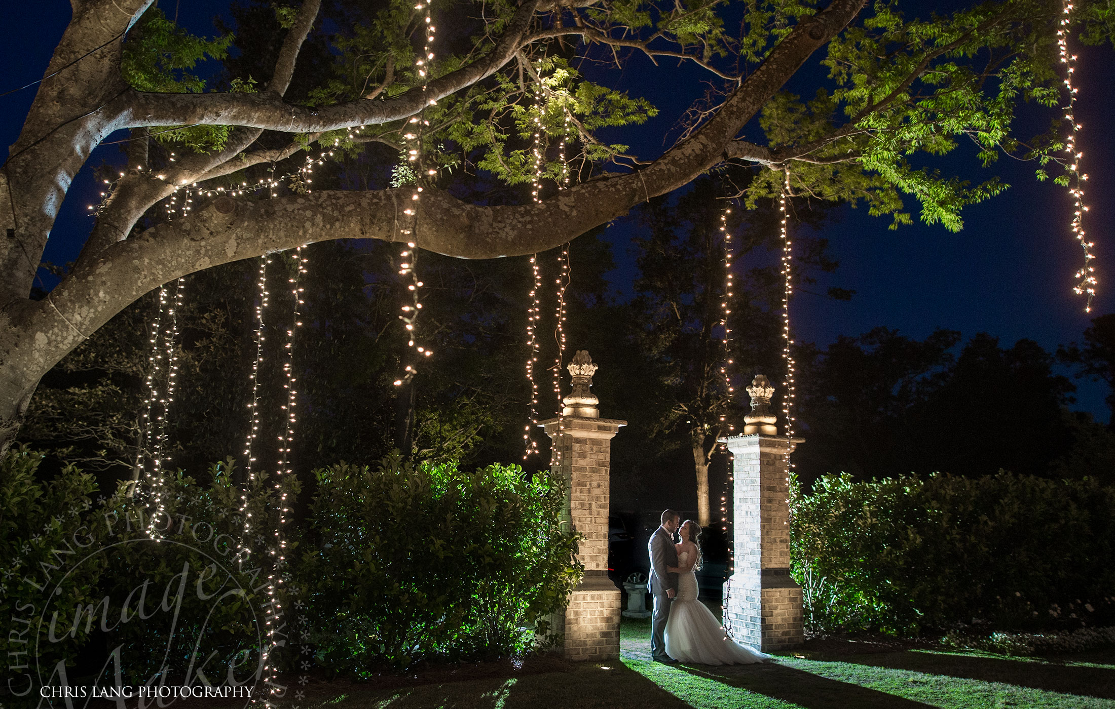 Image of bride and groom in front of the Wrightsville Manor on their wedding day  - Wilmington NC - Wedding Photography - Wedding Venues