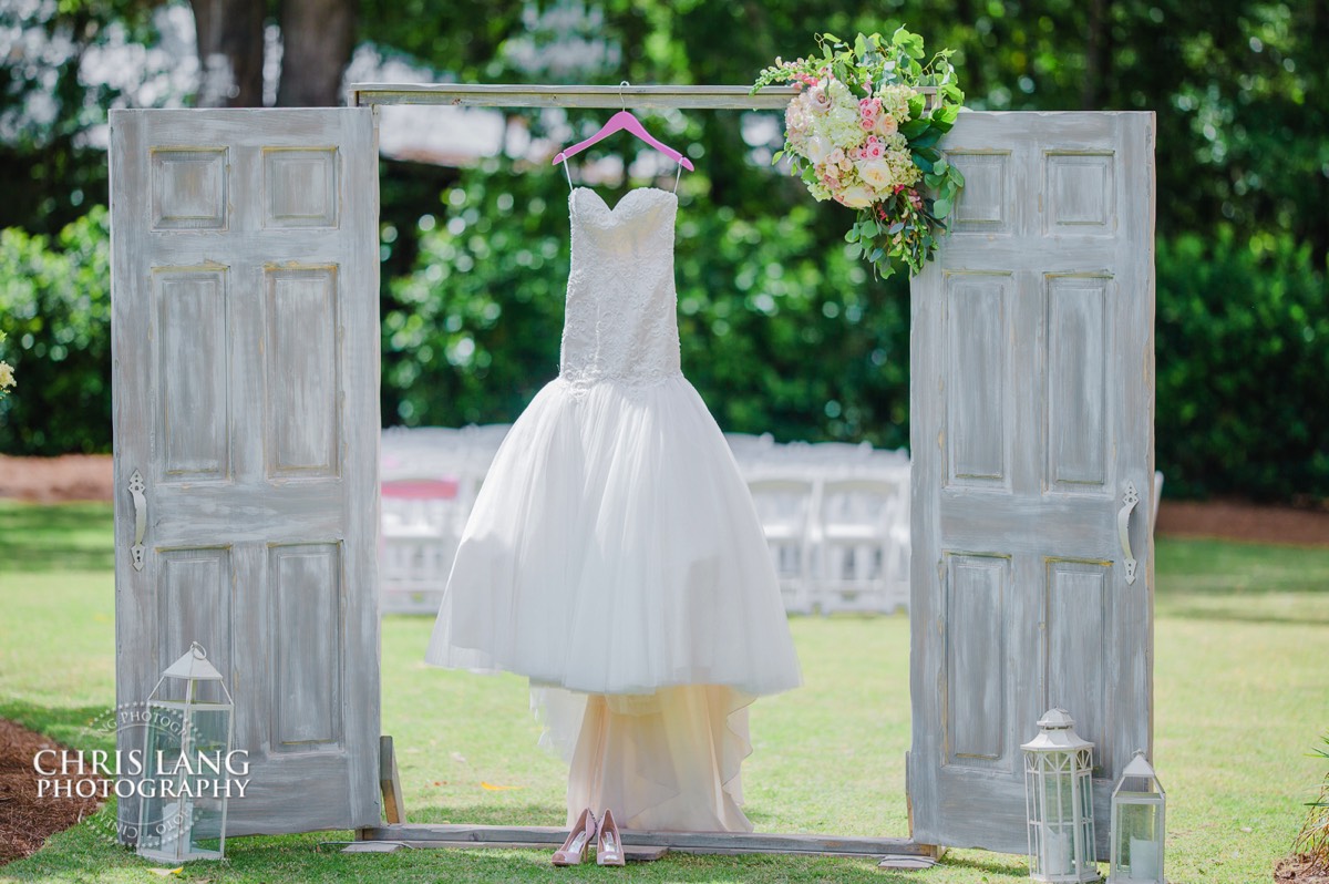 Wedding dress hanging on barn doors at Wrightsville Manor - Wilmington NC Wedding Venue - Wedding picture ideas